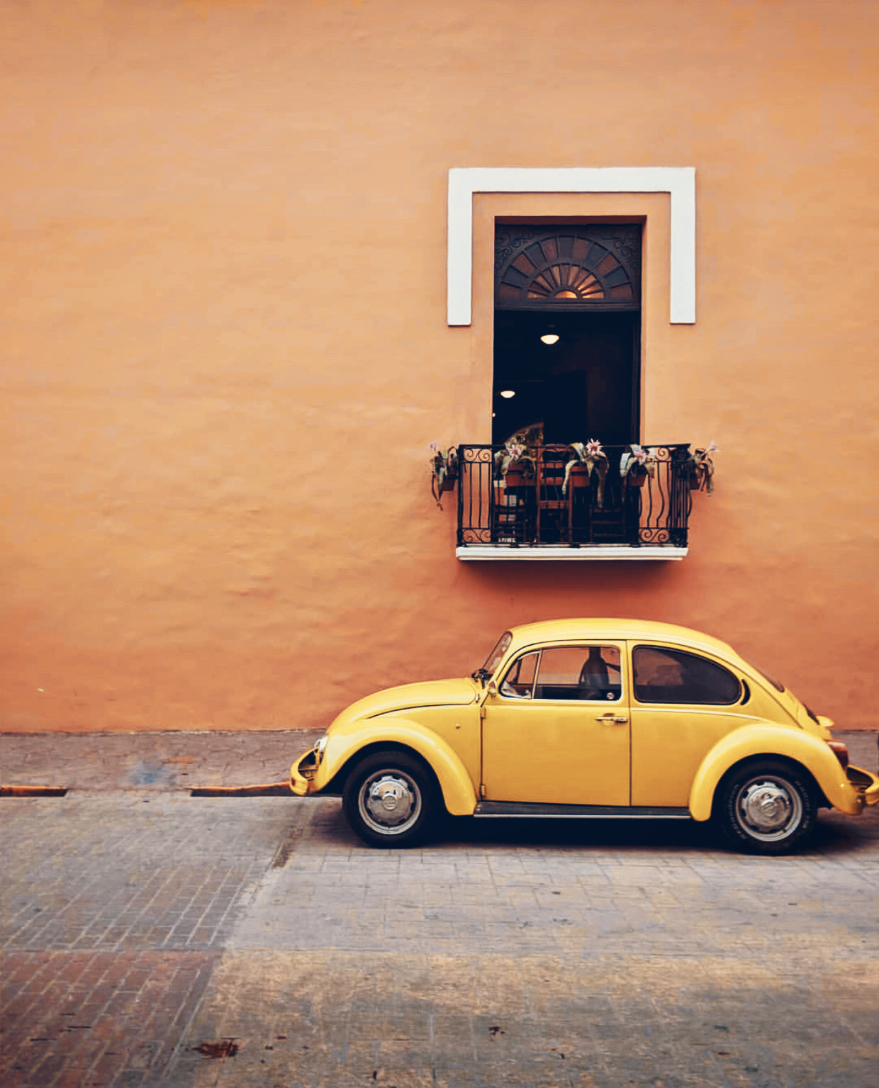 #urbanexploration #housewall #window #balcony #parkedcar #oldcar #wolkswagen #beetle #yellowcar #retro #vintagevibes #minimal #urbanexploringphotography 